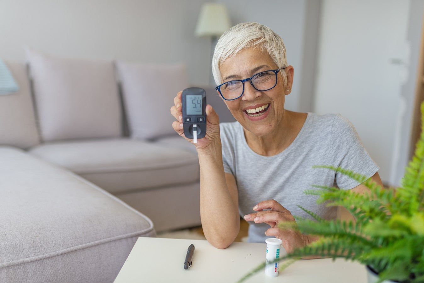 smiling woman showing her phone