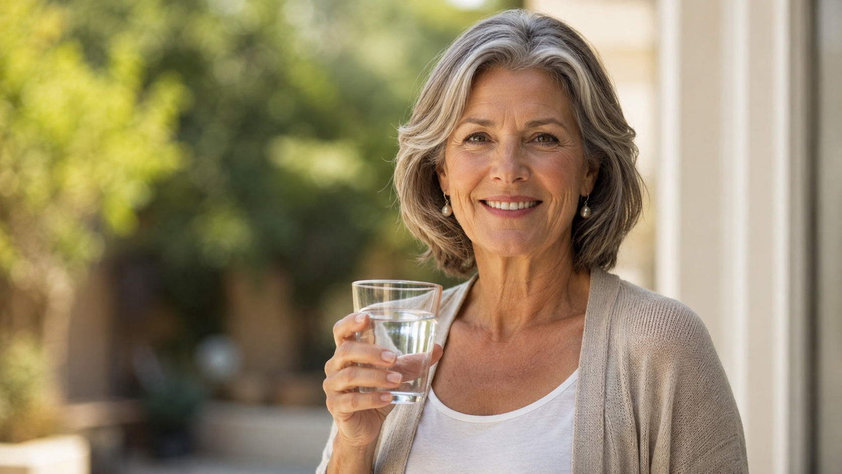 happy woman in her 60s drinking water