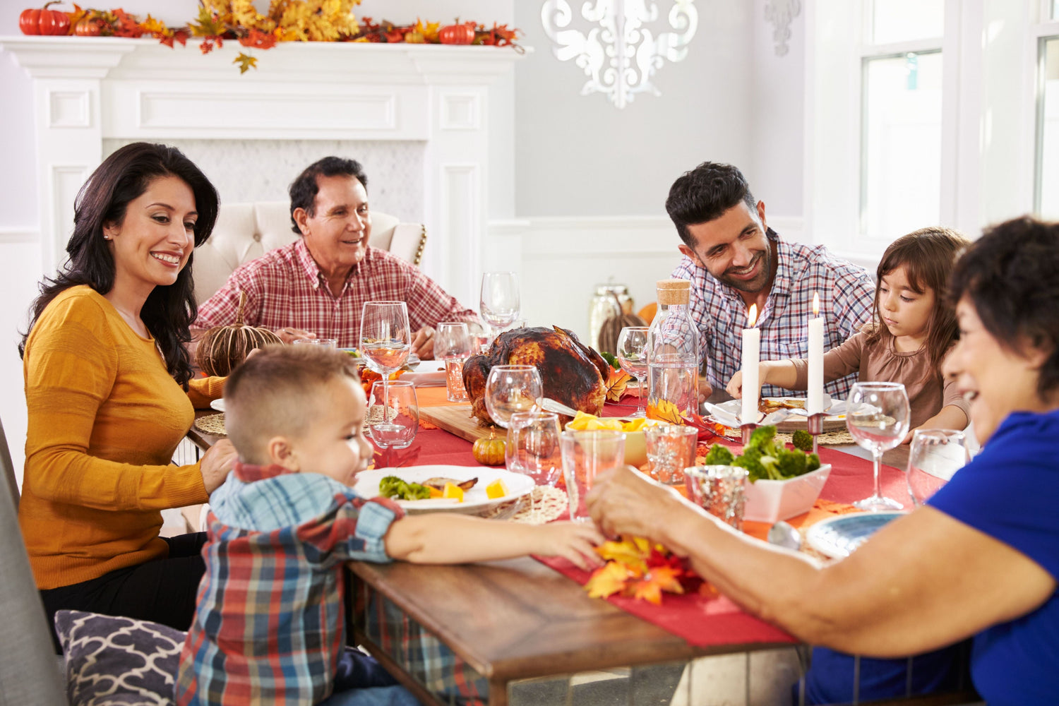 family laughing around thanksgiving table
