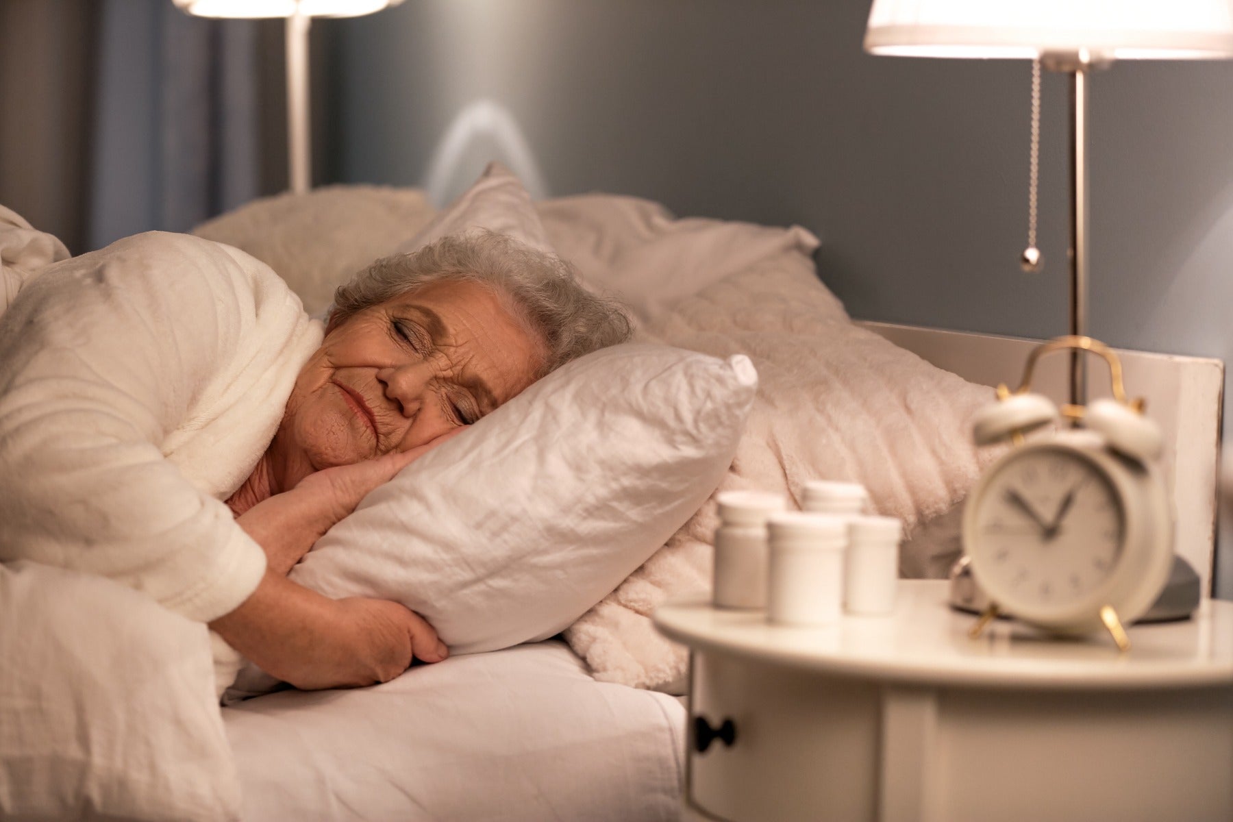 woman sleeping by clock