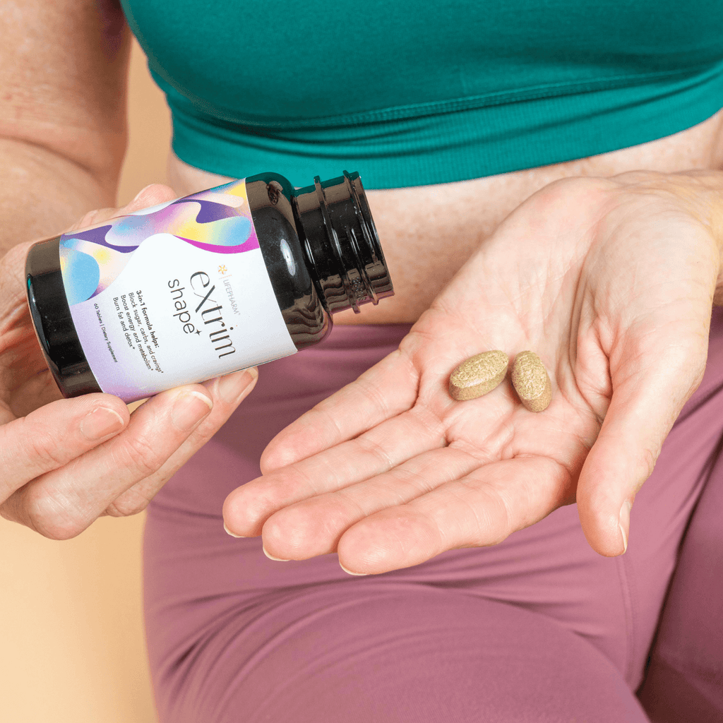 A woman holds a bottle of vitamin pills, emphasizing health and wellness in her daily routine.